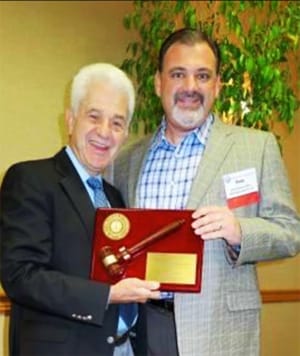 Dr. Russo accepting the Western Society of Periodontology Presidential Gavel from Past President Dr. Greenberg